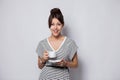 Portrait of a happy young business woman holding cup of coffee isolated over white background. Royalty Free Stock Photo