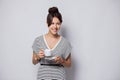 Portrait of a happy young business woman holding cup of coffee isolated over white background. Royalty Free Stock Photo