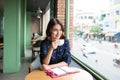 Portrait of happy young business woman with mug in hands drinking coffee in the morning at restaurant Royalty Free Stock Photo