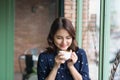 Portrait of happy young business woman with mug in hands drinking coffee in the morning at restaurant Royalty Free Stock Photo