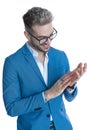 Happy young businessman with glasses rubbing palms and laughing Royalty Free Stock Photo