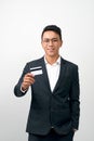 Portrait of handsome young businessman holding credit card over white background Royalty Free Stock Photo