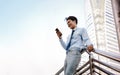 Portrait of a Happy Young Businessman Using Mobile Phone in the Urban City Royalty Free Stock Photo