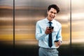Portrait of a Happy Young Businessman Using Mobile Phone in the Urban City. Lifestyle of Modern People. Front View Royalty Free Stock Photo