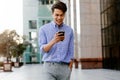 Portrait of a Happy Young Businessman Using Mobile Phone in the Urban City. Lifestyle of Modern People. Front View. Modern Royalty Free Stock Photo