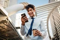 Portrait of a Happy Young Businessman Using Mobile Phone in the Urban City. Royalty Free Stock Photo