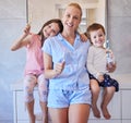 Portrait of happy young caucasian family holding toothbrushes and smiling showing off their healthy teeth. Young mother Royalty Free Stock Photo
