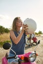 Portrait of happy young caucasian girl putting on helmet Royalty Free Stock Photo