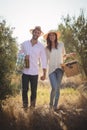 Portrait of happy young couple carrying picnic basket Royalty Free Stock Photo