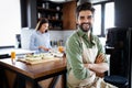 Portrait of happy young couple cooking together in the kitchen at home. Royalty Free Stock Photo