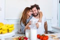 Portrait of happy young couple cooking together in the kitchen at home. romantic Attractive young woman and handsome man are Royalty Free Stock Photo