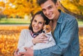 Portrait of happy young couple with dog outdoors Royalty Free Stock Photo