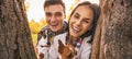 Portrait of happy young couple with dogs outdoors in autumn park Royalty Free Stock Photo