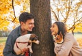 Portrait of happy young couple with dogs outdoors in park Royalty Free Stock Photo