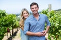 Portrait of happy young couple embracing at vineyard Royalty Free Stock Photo