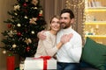 Portrait of a happy young couple, family. Young man and woman celebrating Christmas holidays at home Royalty Free Stock Photo