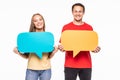 Portrait of a happy young couple holding empty speech bubbles isolated over white background Royalty Free Stock Photo