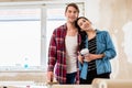 Portrait of a happy young couple holding tools for home remodeli Royalty Free Stock Photo