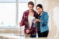 Portrait of a happy young couple holding tools for home remodeling Royalty Free Stock Photo