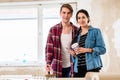 Portrait of a happy young couple holding tools for home remodeling