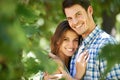 Portrait, happy young couple and hug in nature in the park and bonding outdoors in Italy. Love, relationship and travel Royalty Free Stock Photo