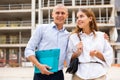 Happy couple visiting construction site