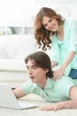 Happy young couple looking at laptop at home Royalty Free Stock Photo
