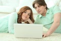 Happy young couple looking at laptop at home Royalty Free Stock Photo