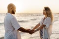 Portrait of happy young couple in love embracing each other on beach Royalty Free Stock Photo