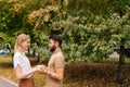 Portrait of happy young couple in love standing at city park and looking at each other with falling in love eyes Royalty Free Stock Photo