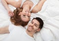 Portrait of happy young couple lying on bed Royalty Free Stock Photo