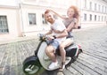 Cheerful young couple riding a scooter and having fun Royalty Free Stock Photo