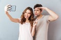 Portrait of a happy young couple showing peace gesture Royalty Free Stock Photo