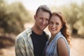 Portrait of happy young couple standing at olive farm Royalty Free Stock Photo