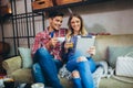 Portrait of happy young couple using a digital tablet together at coffee shop Royalty Free Stock Photo