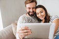 Portrait of a happy young couple using tablet computer Royalty Free Stock Photo