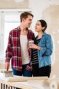 Portrait of a happy young couple holding tools for home remodeli Royalty Free Stock Photo