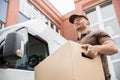 Young Delivery Man Carrying Cardboard Box Royalty Free Stock Photo