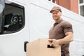 Young Delivery Man Carrying Cardboard Box Royalty Free Stock Photo