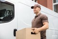 Young Delivery Man Carrying Cardboard Box Royalty Free Stock Photo