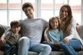 Portrait of happy young family with kids on couch Royalty Free Stock Photo