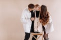 Portrait of a happy young family, with a little adorable daughter. Caring parents holding a baby`s hands. mom and dad kissing Royalty Free Stock Photo