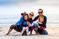 Portrait of happy young family posing on the sandy beach Royalty Free Stock Photo