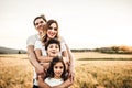 Portrait of a happy young family smiling in the countryside. Concept of family fun in nature Royalty Free Stock Photo