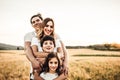 Portrait of a happy young family smiling in the countryside. Concept of family fun in nature Royalty Free Stock Photo