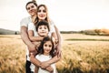 Portrait of a happy young family smiling in the countryside. Concept of family fun in nature Royalty Free Stock Photo