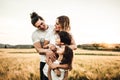 Portrait of a happy young family smiling in the countryside. Concept of family fun in nature Royalty Free Stock Photo