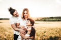 Portrait of a happy young family smiling in the countryside. Concept of family fun in nature Royalty Free Stock Photo