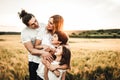 Portrait of a happy young family smiling in the countryside. Concept of family fun in nature Royalty Free Stock Photo