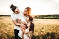 Portrait of a happy young family smiling in the countryside. Concept of family fun in nature Royalty Free Stock Photo